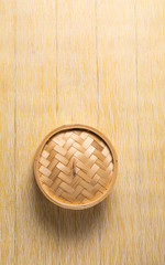 Empty basket of dim sum made by bamboo material. Chinese Traditional cuisine concept. Dumplings Dim Sum in bamboo steamer with text copy space. Asian food background
