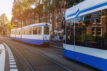 City tram driving throught Amsterdam city at Netherlands
