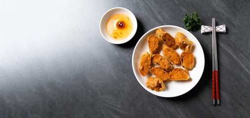 Hae Keung is fried shrimp rolled or shrimp ball. Chinese Traditional cuisine concept. Dumplings Dim Sum in bamboo steamer with text copy space. Asian food background