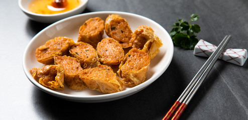 Hae Keung is fried shrimp rolled or shrimp ball. Chinese Traditional cuisine concept. Dumplings Dim Sum in bamboo steamer with text copy space. Asian food background