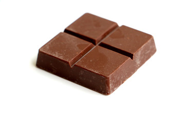 A pile of milk chocolate slab blocks broken up and stacked