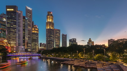 Singapore skyscrapers skyline with white Anderson Bridge near esplanade park day to night timelapse.