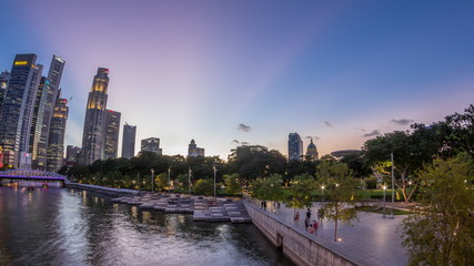 Singapore skyscrapers skyline with white Anderson Bridge near esplanade park day to night timelapse.