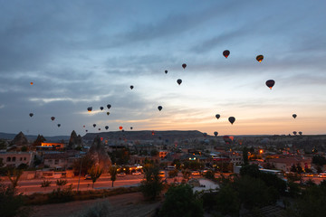 Baloons on the sky and typical Cappadocian landscape, close to Goreme. Nevsehir, Anatolia, Turkey