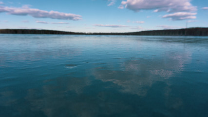 the turquoise sky and the ice of a frozen pond lake