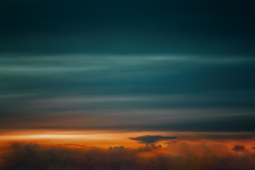 Obraz premium The sky at sunset. Cumulus clouds lit by the rays of the setting sun.