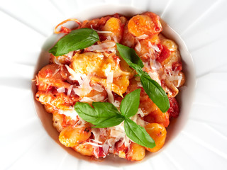 Oven baked gnocchi alla sorrentina, with tomato sauce, mozzarella and green fresh basil