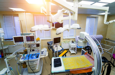 Interior hospital design concept. Interior of operating room in modern clinic. Lamps and ultra modern devices,