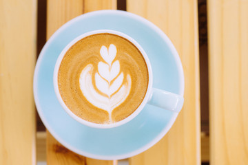 Latte art on wood background