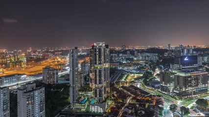 Fototapeta na wymiar City skyline with commercial port of Singapore aerial night timelapse.