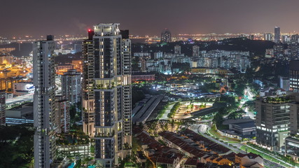 Fototapeta na wymiar City skyline with commercial port of Singapore aerial night timelapse.