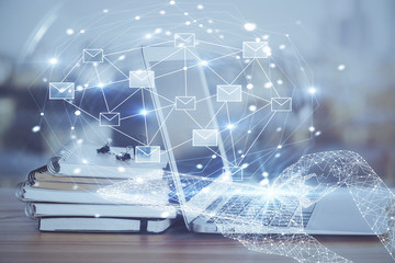 Desktop computer background in office and flying envelops hologram drawing. Multi exposure. Electronic mail concept.