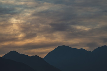 Scenic View of Silhouette Mountains against Sky during Sunset