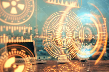 Computer on desktop in office with technology theme hologram. Multi exposure. Tech concept.