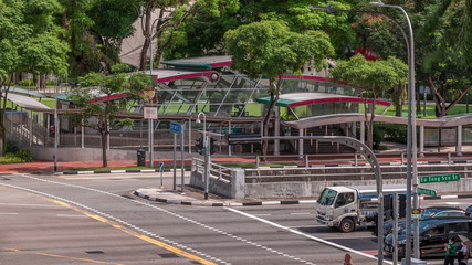 Naklejka premium Traffic with cars on a street and urban scene in the central district of Singapore timelapse