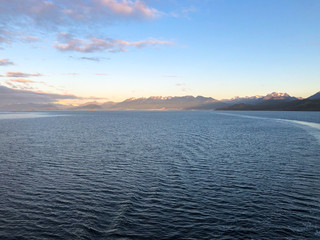 Sunrise over Ushuaia with Full Moon in Patagonia during cruising on luxury cruise ship or...