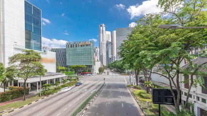 Fototapeta na wymiar Traffic with cars on a street and urban scene in the central district of Singapore timelapse