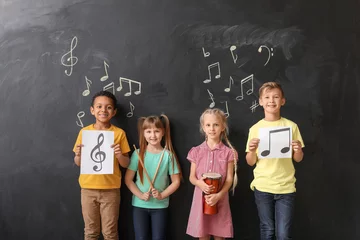 Fotobehang Little children near chalkboard at music school © Pixel-Shot