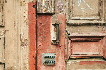 Fototapeta na wymiar Close up of wooden weathered door with rusty and lock