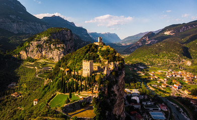 The castle of Arco towering above the vast landscape of Trentino, Italy