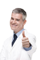 Smiling male doctor or pharmacist giving a thumbs up