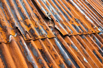 Rusty old metal roof with damaged elements. Closeup