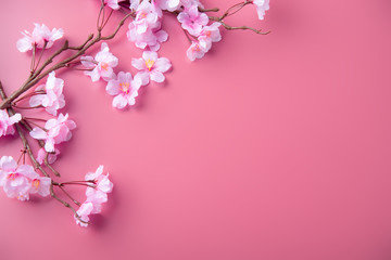 Obraz na płótnie Canvas Artificial cherry blossom flower on pink background. Spring season image.