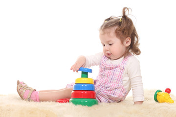 little girl child plays with pyramid