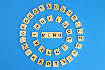 Word menu of wooden letters on a blue background