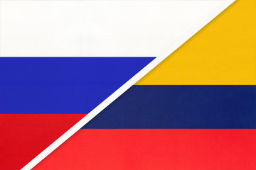 Fototapeta premium Russia vs Colombia national flag from textile. Relationship and partnership between two countries.