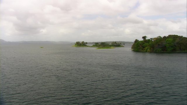 Aerial view of Lake Bayano, small islands with palms and cloud forest in Panama Central America, filmed with Cineflex stabilization camera system