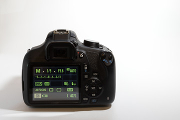 One black camera isolated on white background. Back view