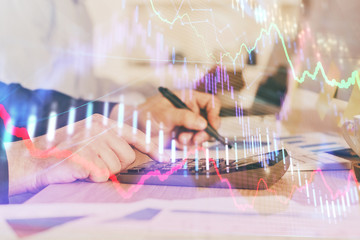 Financial trading graph multi exposure with man desktop background.