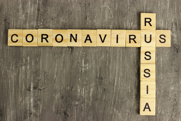 Crossword of the words Coronavirus and Russia from wooden letters. a pandemic outbreak, medical health risk concept, the spread of the virus in the world