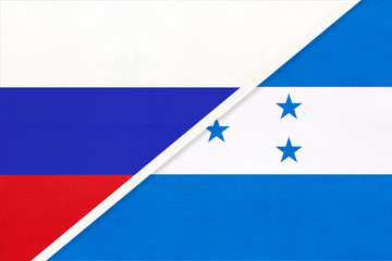 Russia vs Honduras national flag from textile. Relationship and partnership between two countries.
