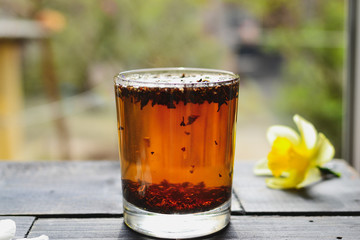 Morning. Tea in a glass cup. Tea time. Sunlight. Tea in a glass and flowers.