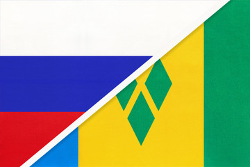 Russia vs Saint Vincent and Grenadines national flag from textile. Relationship and partnership between two countries.