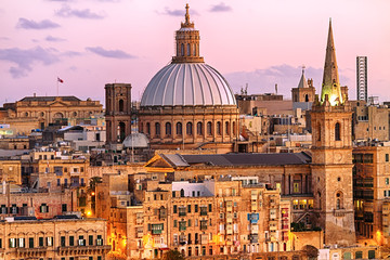 Fototapeta na wymiar Skyline of Valletta St Paul's Pro-Cathedral and Basilica Our Lady of Mount Carmel at sunset, Malta.