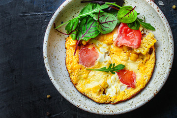 omelette scrambled vegetables and salad, healthy snack (corn, tomato, onion and other ingredients) menu concept background. top view. copy space for text