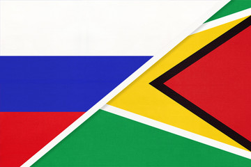 Russia vs Republic of Guyana national flag from textile. Relationship and partnership between two countries.
