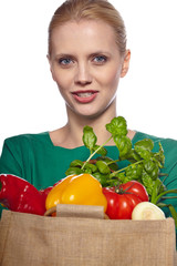 Woman holding grocery paper shopping bag full of fresh vegetables. Diet healthy eating concept isolated on a white background