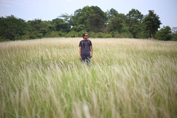 A man standing in grass color white, Thailand