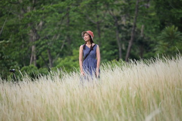 A woman standing in grass color white, Thailand