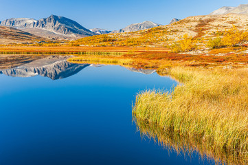 Mountains reflecting in lake at autumn, Norway, 