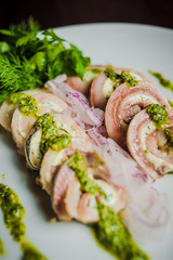 rolls of herring fish and soft cheese with pesto
