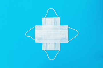 Medical masks for protection from virus and bacteria on a blue background. Epidemic concept. Flat lay.