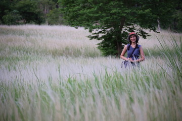 A woman standing in grass color white, Thailand