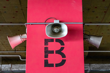 System of alert for population. Mounted on concrete poles under the ceiling of a building to inform...
