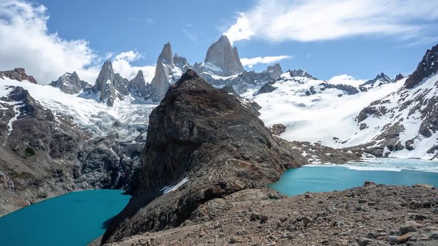 Fritz Roy Mountain Timelapse. Moving Clouds Over Mountain Summit and Laguna de Los Tres Lake on Sunny Day