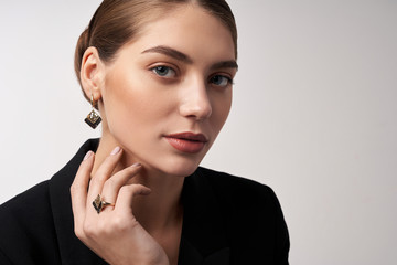 Young brunette model demonstrating jewelry.